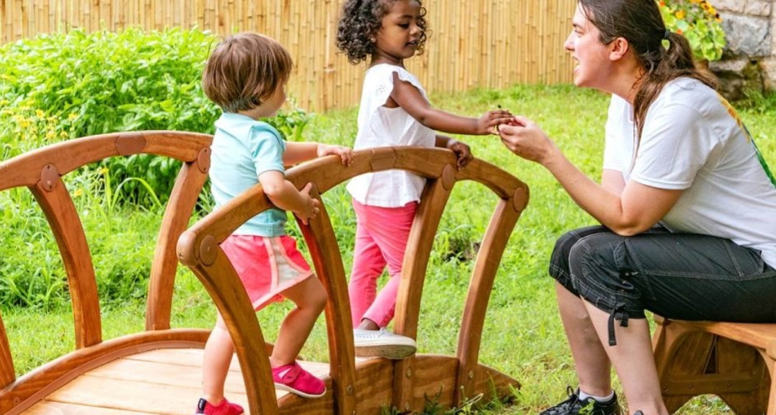 two children playing on a toy bridge