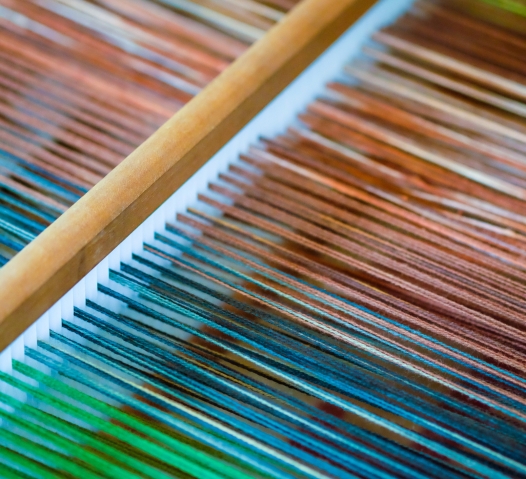 Close shot of multicolored yarn on a loom